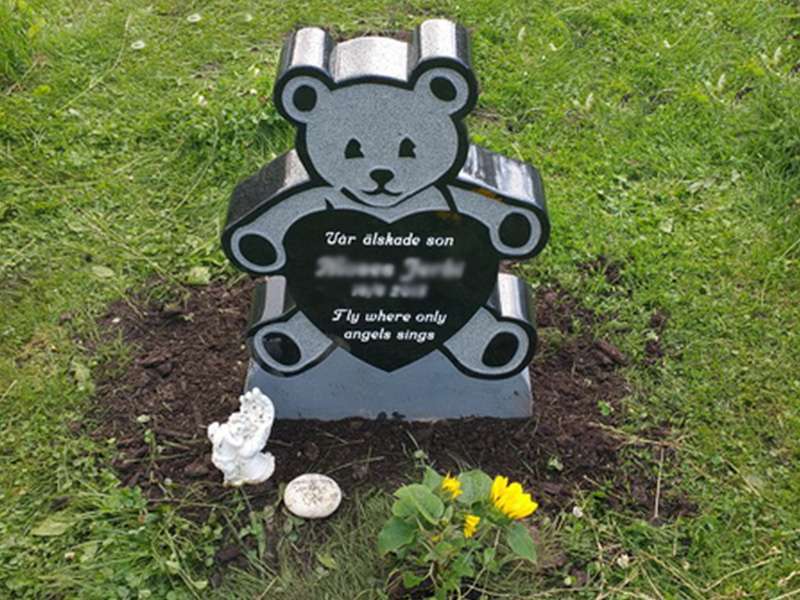 E050 in black granite. The engraving is recessed and painted white.