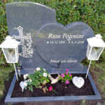 E044 in dark grey granite. Recessed, antique white engraving and a polished flower border.