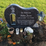 E061 in polished Indian blue-grey granite. Chrome-plated bronze lantern and recessed, silver-painted engraving.