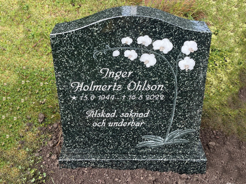 E009 in green-gray granite in customized dimensions. Intarsia plus text that is recessed and painted antique white.