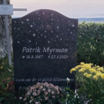 E009 in Indian blue-gray granite. Custom designed motif with recessed text painted silver.