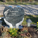 E005 in Labrador granite. Recessed engraving painted antique white.