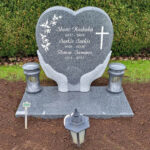 E005 in dark gray granite with a deep base and granite lanterns. Recessed engraving painted antique white.