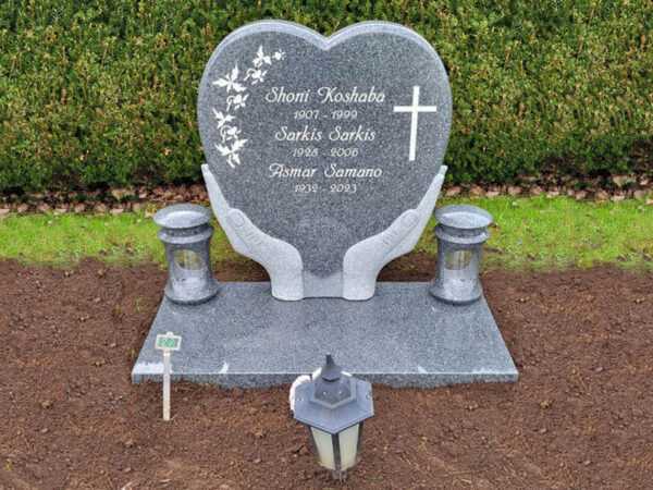 E005 in dark gray granite with a deep base and granite lanterns. Recessed engraving painted antique white.