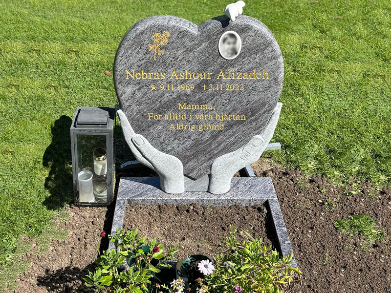 E005 in Indian blue-gray granite with a flower ledge, porcelain photo, and marble dove. The engraving is recessed and gilded.