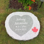 EN114 in fine-polished and fine-chiseled grey Kuru granite. Recessed antique-white text and recessed decoration in a custom color outside standard range.